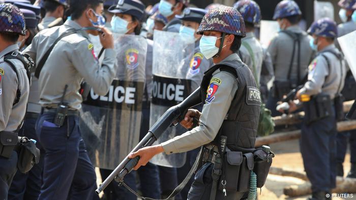 Myanmar police officer with a gun