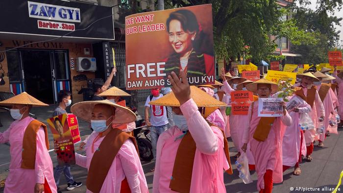 Buddhist nuns display images of deposed Myanmar leader Aung San Suu Kyi during a street march in Mandalay