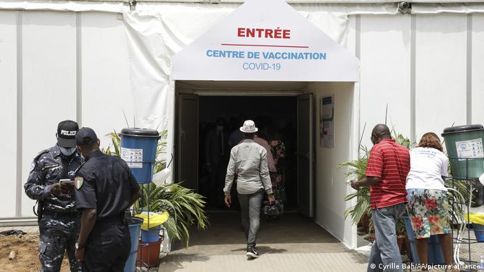 People walk into a covid vaccination center in Ivory Coast.