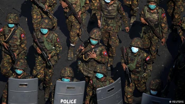 Myanmar soldiers patrol a street in Yangon during a protest against the military coup 
