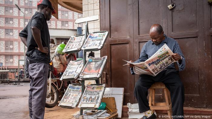 A man sells newspapers in Kampala, Uganda