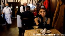 Madame Tussauds's wax figure of Audrey Hepburn sits at an empty table to comply with coronavirus disease (COVID-19) social distancing requirements in a dining room at Peter Luger Steak House in Brooklyn, New York U.S., February 26, 2021. REUTERS/Brendan McDermid