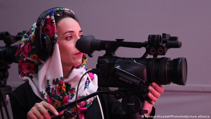 An Afghan woman in a hijab records a program at Zan TV in Kabul