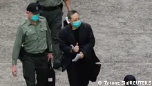 Pro-democracy activist Benny Tai flashes thumbs up as he walks to a prison van to head to court, over the national security law charge, in the early morning, in Hong Kong, China March 2, 2021. REUTERS/Tyrone Siu