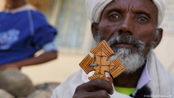 An Orthodox priest shows off his cross.