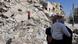 A Syrian man carries his child past damaged buildings in Maaret al-Numan, in the northwestern province of Idlib, Syria, on March 20, 2013 A Syrian man carries his child past damaged buildings in Maaret al-Numan, in the northwestern province of Idlib, Syria, on March 20, 2013