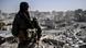 A soldier stands guard on a rooftop in Syria's Raqqa. A soldier stands guard on a rooftop in Syria's Raqqa.