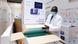Man in white coat checking consignment of vaccines Man in white coat checking consignment of vaccines