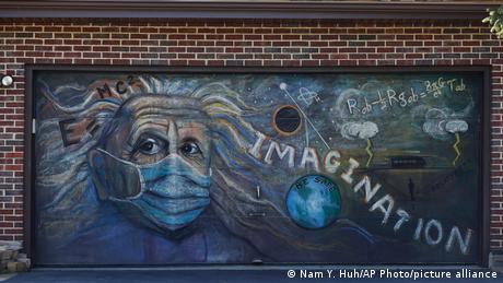 An image of Einstein wearing a mask with the word Imagination written next to him. 