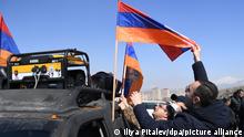 6481299 06.03.2021 Men fix Armenian flag on the car during a rally in support of the General Staff in its conflict with Prime Minister Nikol Pashinyan near the Armenian Defence Ministry in Yerevan, Armenia. Iliya Pitalev / Sputnik