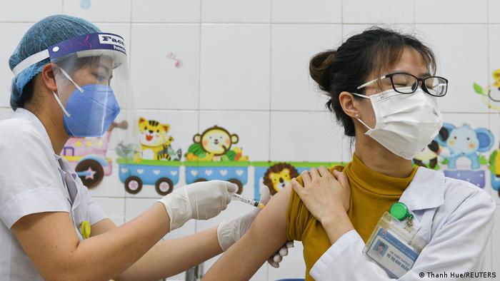 A woman receives the AstraZeneca vaccine in Hai Duong province, Vietnam