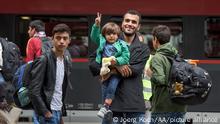 MUNICH, GERMANY - SEPTEMBER 6: Refugees who travelled by train to the main railway station 'Munich Hauptbahnhof' leave the train under control by police and enter another one to get to a refugee centre on September 06, 2015 in Munich, Germany. Hundreds of refugees, mainly from Syria and Iraq, arrive in Germany after Hungary has opened his borders for them to travell on to Germany and Austria. Joerg Koch / Anadolu Agency
