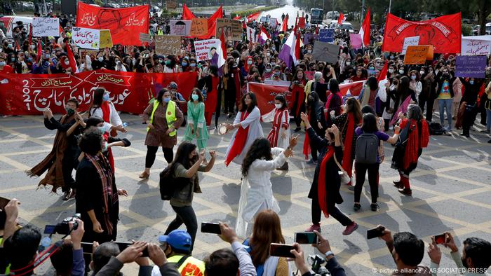 Activists dance in a circle at a rally to mark International Women's Day, in Islamabad, Pakistan, Monday, March 8, 2021.