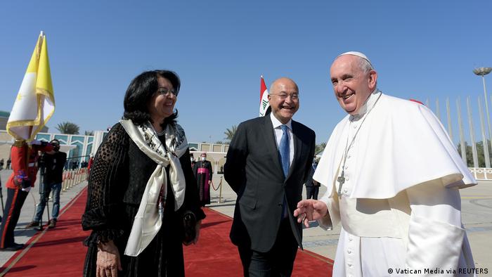 Pope Francis (right) pictured with Iraq's President Barham Salih (center) and his wife Sarbagh Salih (left) before departing from Baghdad International Airport