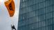 A Greenpeace activist flies with a motorized paraglider past the ECB in Frankfurt, Germany, to protest against the bank's climate policy A Greenpeace activist flies with a motorized paraglider past the ECB in Frankfurt, Germany, to protest against the bank's climate policy