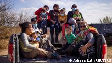 Migrant families and children sit in the back of a police truck for transport after they crossed the Rio Grande River into the United States from Mexico in Penitas, Texas, U.S., March 5, 2021. REUTERS/Adrees Latif TPX IMAGES OF THE DAY