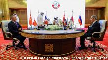 In this photo released by Russian Foreign Ministry Press Service, Turkish foreign minister Mevlut Cavusoglu, left, Qatar's Deputy Prime Minister and Minister of Foreign Affairs Mohammed bin Abdulrahman Al Thani, center, and Russian Foreign Minister Sergey Lavrov attend the talks in Doha, Qatar, Thursday, March 11, 2021. (Russian Foreign Ministry Press Service via AP)