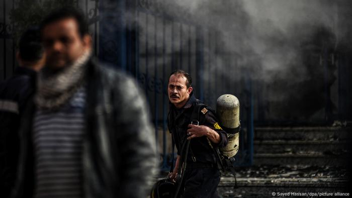 An Egyptian firefighter works to put out a blaze at a factory north of Cairo