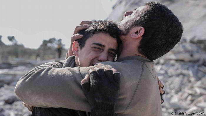 A photos from the Syrian photographer Ghaith Alsayed shows two brothers mourning