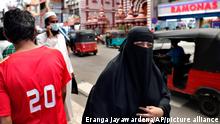 13.3.2021***A burqa clad Sri Lankan Muslim woman walks in a street of Colombo, Sri Lanka, Saturday, March 13, 2021. Sri Lanka on Saturday announced plans to ban the wearing of burqas and said it would close more than 1,000 Islamic schools known as madrassas, citing national security. (AP Photo/Eranga Jayawardena)