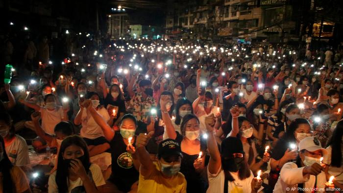 Protesters holding up cell phones with LED lights on in Yangon Protesters holding up cell phones with LED lights on in Yangon