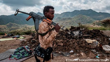 A member of the Afar Special Forces stands in front of the debris of a house in the outskirts of the village of Bisober, Tigray Region.