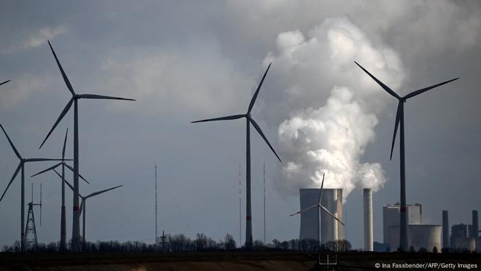 Wind turbines are seen near the coal-fired power station Neurath of German energy giant RWE in Garzweiler,