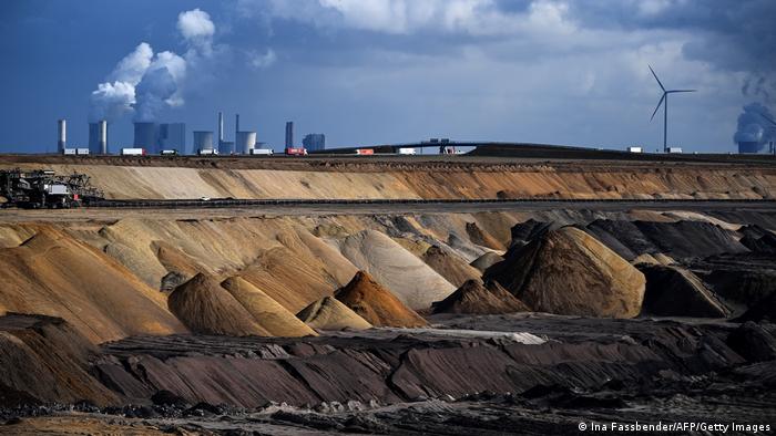 Coal plants near wind turbines behind an open-cast coal mine in Germany