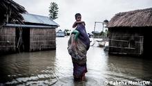 A mother is trying to cross floodwater with her child. Bangladesh is one of the most densely populated nations on Earth. It has more people than geographically massive Russia. Bangladesh in the year 2050, when its population will likely have 220 million and a good amount of its current landmass could be permanently underwater. Scientists are predicting that climate change could lead to a rise in sea levels that would flood at least 17 percent of Bangladesh and create around 20-35 million refugees by 2050. Gaibandha, Bangladesh