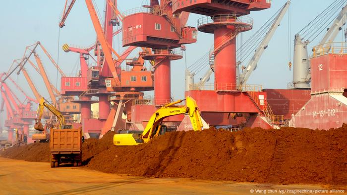 An excavator loads a truck with rare earth at the Port of Lianyungang