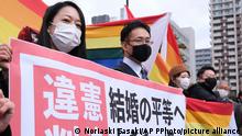 The plaintiff's lawyers hold a banner that says unconstitutional judgement, Big step to equal marriage rights, after the same-sex marriage lawsuit in front of Sapporo District Court in Sapporo, Hokkaido Prefecture on March 17, 2021. Three same-sex couples in the prefecture had claimed for damages against the government. The district court rejected the restitution for damages however ruled that refusing the same-sex marriages is illegal.( The Yomiuri Shimbun via AP Images )