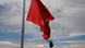 The Kyrgyz national flag flies at half staff in front of the statue Lenin The Kyrgyz national flag flies at half staff in front of the statue Lenin