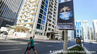 An advertisement board on display in a street in Dubai, advising residents to remain at home due to the COVID-19 coronavirus pandemic.
