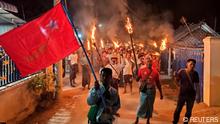 Protesters hold firelight as they join in nationwide night protest against the coup in Khin Oo, Sagaing region, on March 13