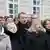 Андрій Садовий (у центрі) та співробітники мерії під час виконання гімну України на площі Ринок 10 березня