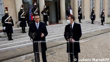Polish Prime Minister Mateusz Morawiecki (L) answers the press as he meets with French President Emmanuel Macron at the Elysee Palace on March 17, 2021. (Photo by Ludovic MARIN / AFP)