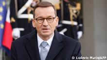 Polish Prime Minister Mateusz Morawiecki answers the press as he meets with French President at the Elysee Palace on March 17, 2021. (Photo by Ludovic MARIN / AFP)