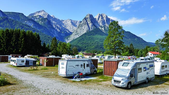 Germany, Motorhomes parked at a campsite at the foot of the Zugspitze in the Alps