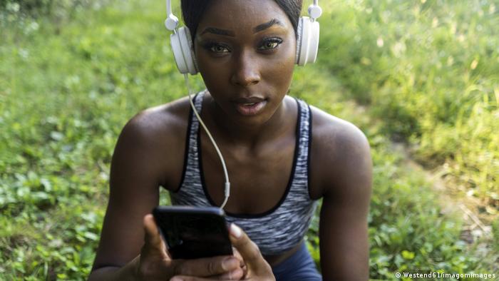 A young women listening to music on headphones