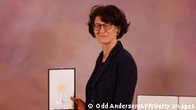 German scientist, CMO and co-founder of BioNTech Ozlem Tureci poses with her Federal Cross of Merit (Bundesverdienstkreuz) awarded to him by German President Frank-Walter Steinmeier (not in picture) on March 19, 2021 at the presidential Bellevue Palace in Berlin. (Photo by Odd ANDERSEN / various sources / AFP) (Photo by ODD ANDERSEN/POOL/AFP via Getty Images)