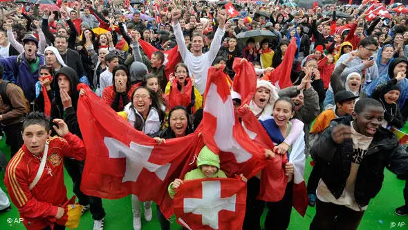 Swiss soccer fans celebrate at the end of the FIFA 2010 World Cup group H soccer match between Switzerland and Spain, at a fan zone in Lausanne, Switzerland, Wednesday, June 16, 2010. Spain lost 0-1 (AP Photo / KEYSTONE / Dominic Favre)