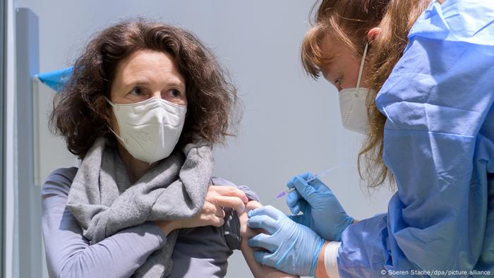 A woman receiving a COVID vaccine at a vaccination center in Berlin