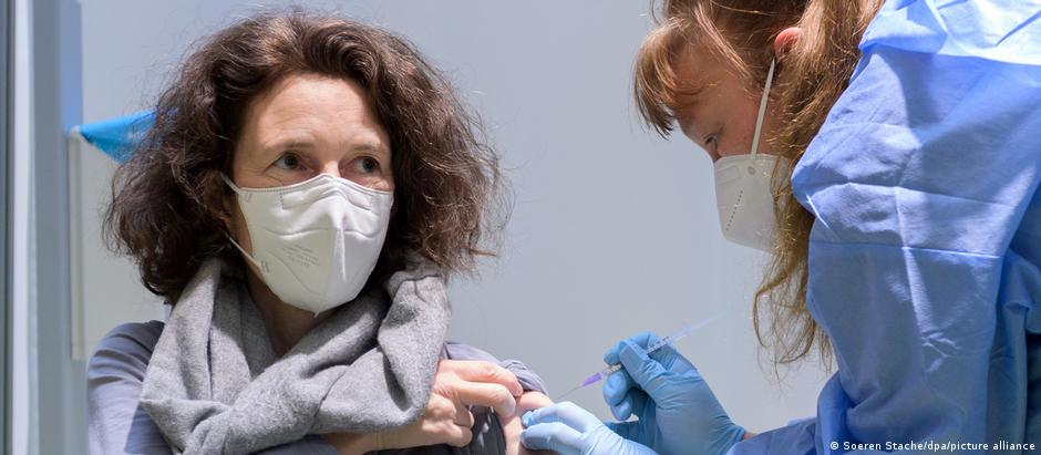 A woman receives a coronavirus vaccine at a vaccination center in Berlin, Germany