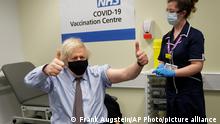 Britain's Prime Minister Boris Johnson gestures after receiving the first dose of the AstraZeneca vaccine administered by nurse and Clinical Pod Lead, Lily Harrington at St.Thomas' Hospital in London, Friday, March 19, 2021. Johnson is one of several politicians across Europe, including French Prime Minister Jean Castex, getting a shot of the AstraZeneca vaccine on Friday. (AP Photo/Frank Augstein, Pool)