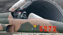 A Taiwan air force pilot signals from a U.S. made f-5E tiger ii fighter jet before take off for a training exercise during military exercises in Taitung County, eastern Taiwan, Tuesday, Jan. 30, 2018. Taiwan military started a two-day joint forces exercises on Tuesday to show its determination to defend itself from Chinese threats. (AP Photo/Chiang Ying-ying)