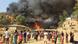 People watch the massive fire at the Balukhali refugee camp People watch the massive fire at the Balukhali refugee camp