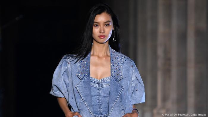 A model wears a denim jacket over a denim top