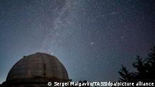 CRIMEA, RUSSIA - AUGUST 13, 2020: The Milky Way along with traces of the passing Perseid meteor shower visible in the sky over a solar tower of the Crimean Astrophysical Observatory under the Russian Academy of Sciences, located in the village of Nauchny, Bakhchisaray District, southwestern Crimea. Sergei Malgavko/TASS