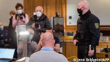 Defendant Philipp S. (C), a former Bundeswehr soldier of the Special Forces Command (KSK) waits in the courtroom for the beginning of his trial for violation of the War Weapons Control Act, on January 22, 2021 at the Leipzig Regional Court in Leipzig. - In May 2020, weapons and ammunition had been found during a search on the accused's property in northern Saxony, including an AK-47 assault rifle, explosives and a large arsenal of ammunition. (Photo by JENS SCHLUETER / AFP)