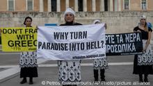 Women hold banners during a environmental protest outside the Greek Parliament in central Athens, Monday, May 4, 2020. Environmental groups in Greece are urging the public to join a campaign against plans by the center-right government to overhaul off-shore oil-and-gas exploration rules which authorities argue will help the country end its dependency on coal. (AP Photo/Petros Giannakouris)